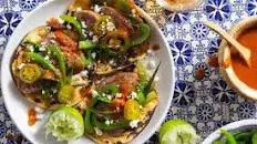 Sausage tacos with bell pepper, chile salsa, and queso fresco