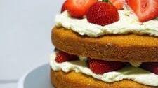 Classic Victoria Sponge Cake with cream and fresh strawberries