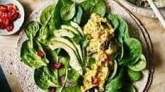 Scrambled egg wrap with Indian spices, avocado and greens