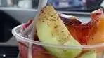 Mexican Fruit Vendors making fruit cups with chamoy and tajin ...