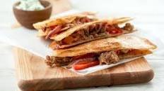 Sausage and Peppers Quesadillas with basil pesto crema