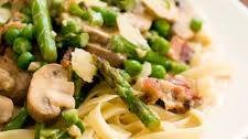 Pasta primavera with asparagus, peas, mushrooms, and bacon
