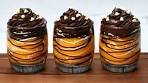 Delicious chocolate dessert with oranges in cups.