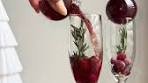 A cranberry mimosa, with edible glitter, served in a Christmas ...