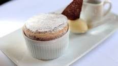 Dark cherry soufflé with clotted cream ice cream and dark chocolate sauce