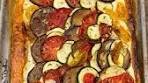 Ratatouille tart. Tomato, aubergine and courgette on a bed of ...