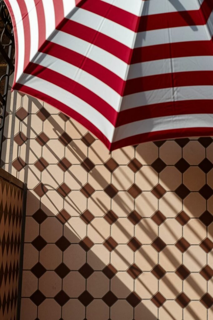 3. Classic Checkerboard with a Striped Umbrella