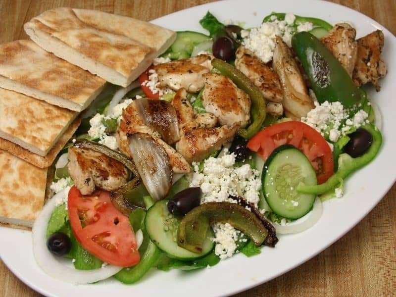 chicken kabob with greek salad and pita bread