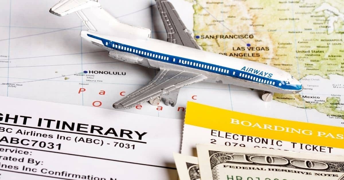 Model airplane on travel documents and currency, symbolizing travel planning and expenses.