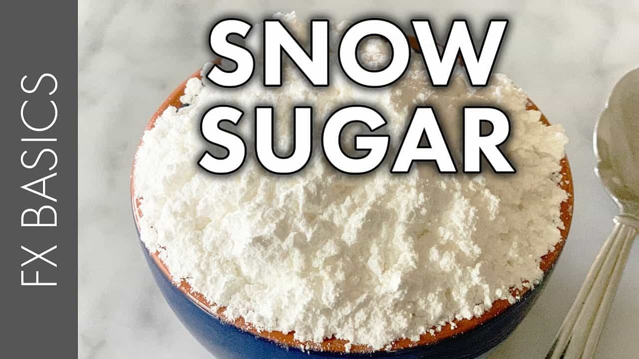 Bowl of snow sugar, a finely powdered sugar used for baking and decorating desserts, with a soft, fluffy texture.