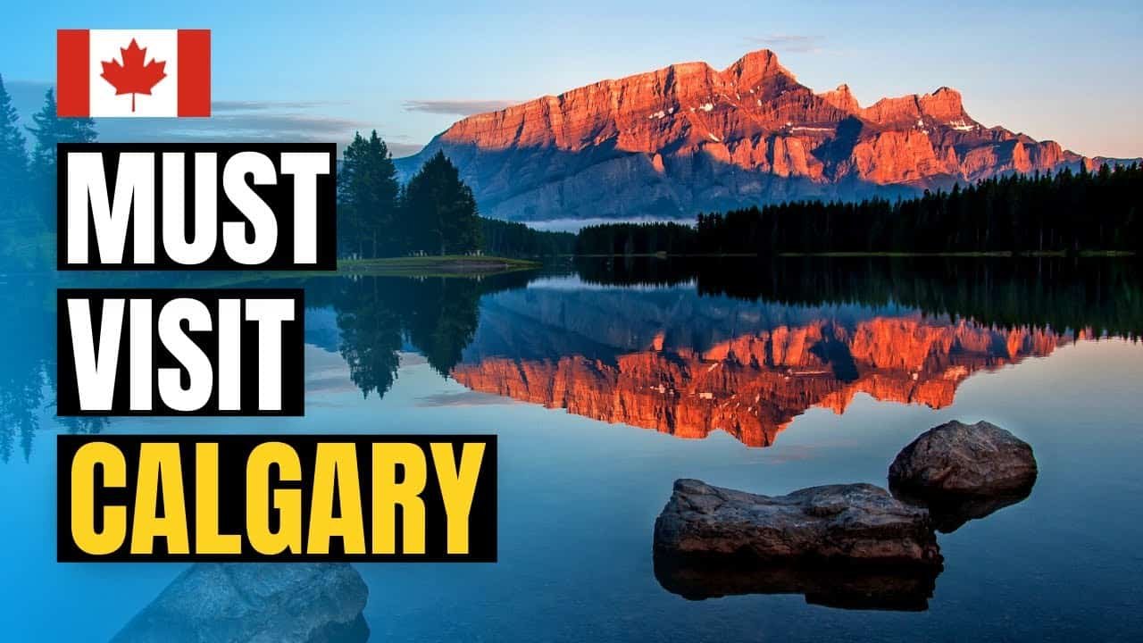 Scenic view of mountains reflecting in a calm lake at sunrise, showcasing the natural beauty of Alberta, Canada, with bold text highlighting "Best at Banff."