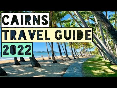 Cairns travel guide 2022 featuring a scenic beach pathway lined with palm trees, showcasing the tropical beauty of Cairns, Australia.