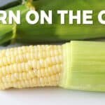 Fresh corn on the cob with green husks, showcasing plump yellow kernels and a vibrant appearance, ideal for summer recipes and grilling.