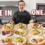 Chef showcasing a variety of healthy meal options on plates, featuring colorful salads, grilled meats, and fresh fruits, in a modern kitchen setting.