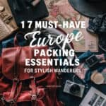 Flat lay of travel essentials for Europe, featuring a stylish red backpack, vintage maps, a camera, sunglasses, and travel accessories, with text overlay highlighting "17 Must-Have Europe Packing Essentials for Stylish Wanderers."