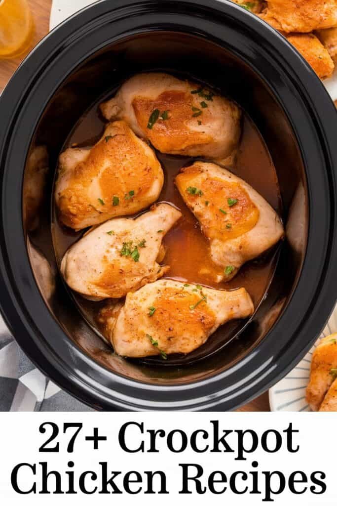 Crockpot chicken thighs cooking in a black slow cooker, surrounded by savory sauce and garnished with fresh herbs, showcasing a collection of over 27 delicious chicken recipes.